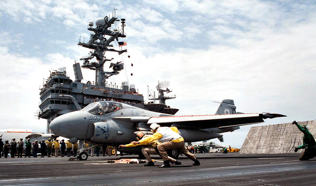 Deck handlers salute as the last Grumman A-6E Intruder launches from the flight deck of the aircraft carrier USS George Washington (CVN 73) on July 22, 1996 after the Intruder’s final deployment.